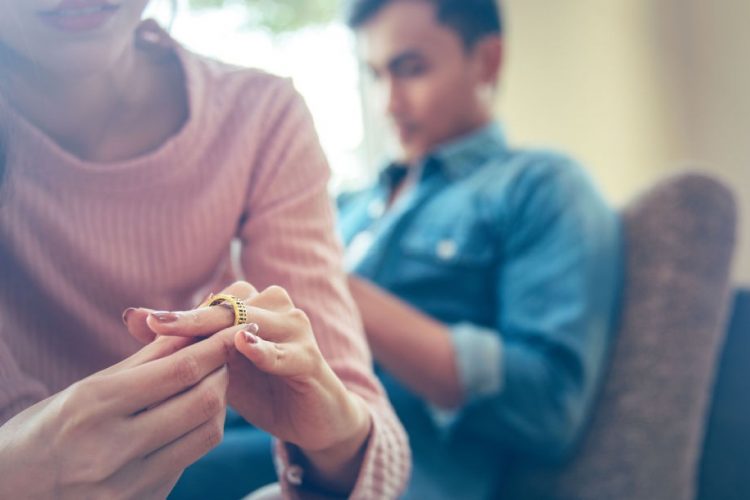 A woman looking at her wedding ring