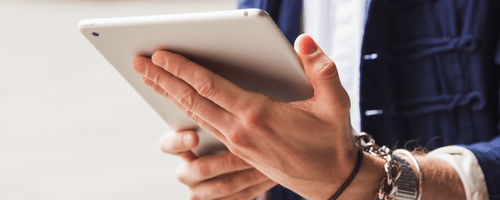 Hands holding a white tablet